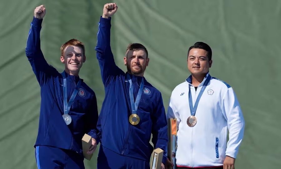 Vincent Hancock, Conner Prince and Lee Meng Yuan celebrate their medals. (Photo: Manish Swarup/AP)