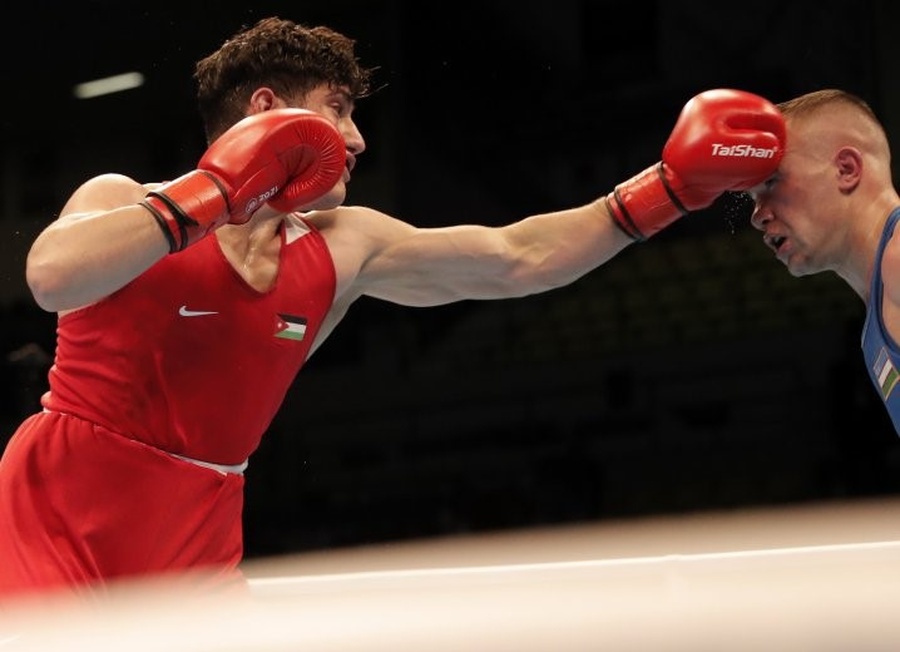 Jordan's Hisham El-Simreen (left) fights Uzbekistan's Fanat Kakhramonov. © Jordan Olympic Committee