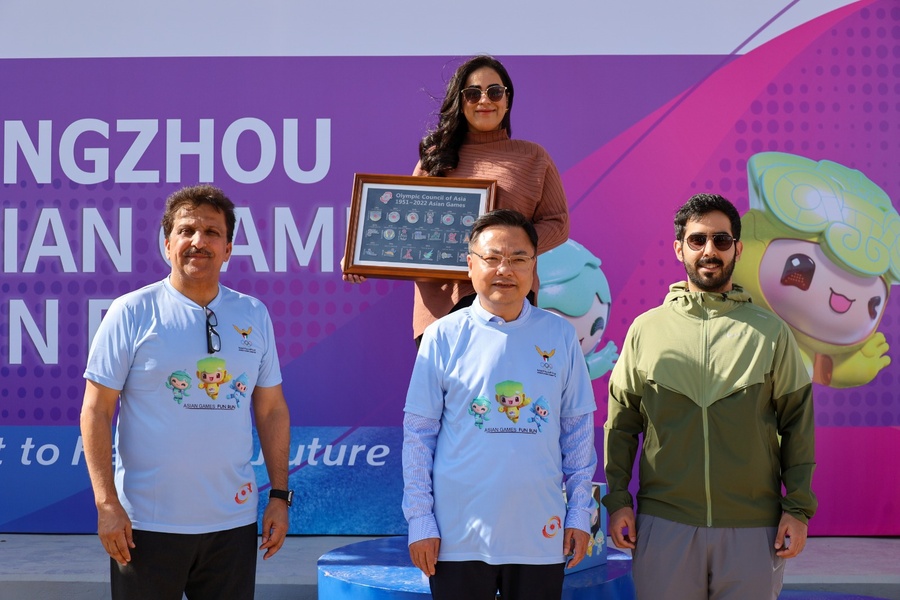 Shaikhah Al Tamimi is pictured with the Hangzhou Asian Games mascots and Asian Games pin badge collection at Kuwait Olympic Committee HQ on Monday. © OCA