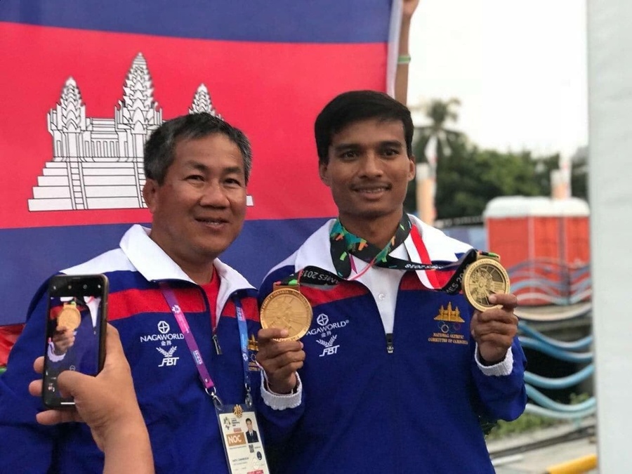 Saly Ou Moeut (right) is pictured with Cambodia NOC Secretary General Vath Chamroeun at the 18th Asian Games in 2018. © NOCC