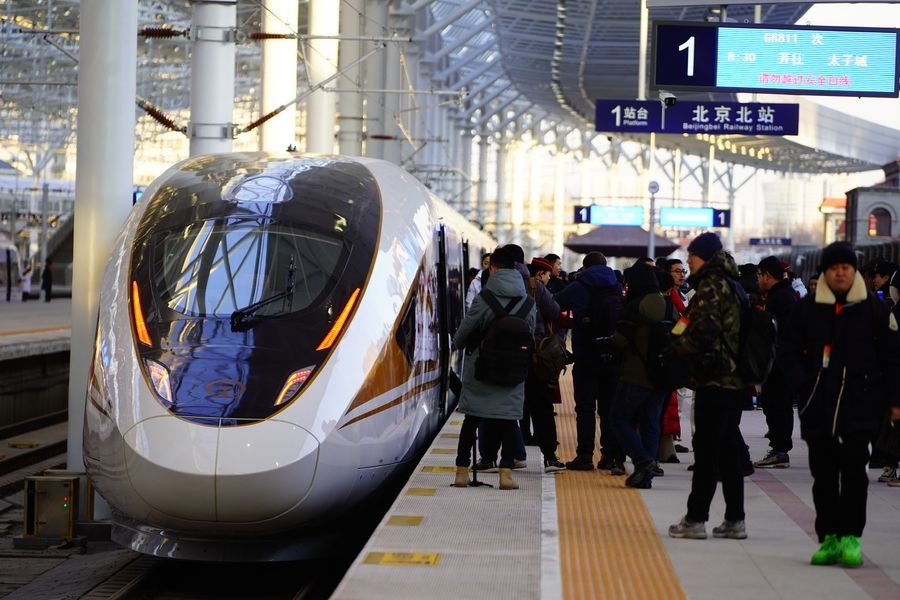 Passengers wait to board the G8811 high-speed train bound for Taizicheng Railway Station at Beijing North Railway Station on December 30, 2019.The new line is 174km long with 10 stops. © Xinhua/Xing Guangli