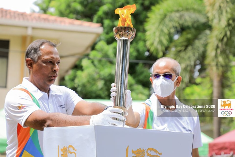 Mr. Suresh Subramaniam, President of NOC Sri Lanka, and Mr. Maxwell de Silva, Secretary General of NOC Sri Lanka, place the Olympic Torch on the Olympic Cauldron on Olympic Day 2020. — at National Olympic Committee of Sri Lanka.