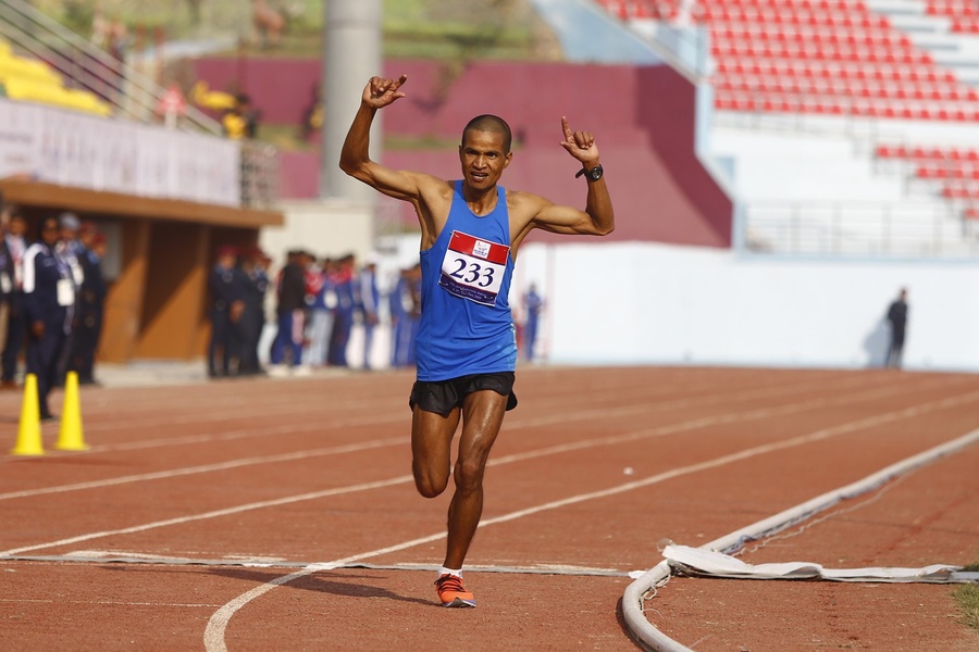 13th South Asian Games marathon winners Kiran Singh Bogati of Nepal and Hiruni Wijeyratne of Sri Lanka celebrate as they cross the finish line at Dasharath Stadium on Saturday. © 13SAGNepal.com