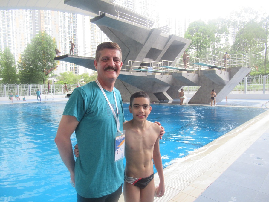 Iraq coach Ahmed Al-Sattar and his athlete Ahmed Al-Zinkee take a breather at the diving pool on Tuesday afternoon. © OCA