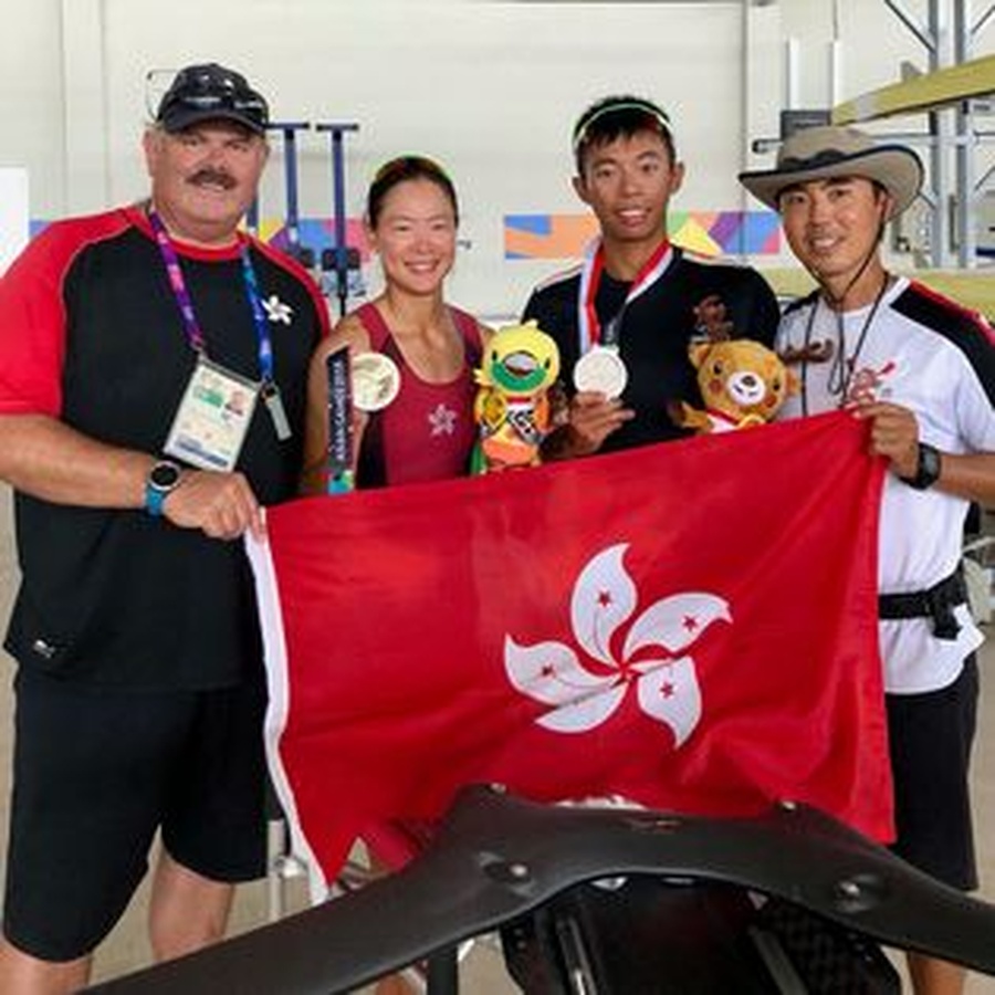 Chris Perry (left) proudly displays the Hong Kong SAR flag.