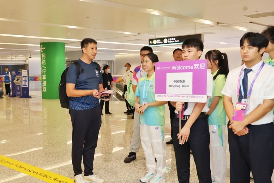 Edward Chow of the Sports Federation and Olympic Committee of Hong Kong, China is welcomed on his arrival in Hangzhou.