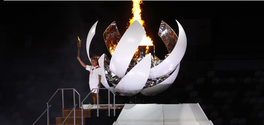 Naomi Osaka lights the Olympic cauldron with the Olympic torch during the Opening Ceremony of the Tokyo 2020 Olympic Games at Olympic Stadium on July 23, 2021. © Maddie Meyer/Getty Images