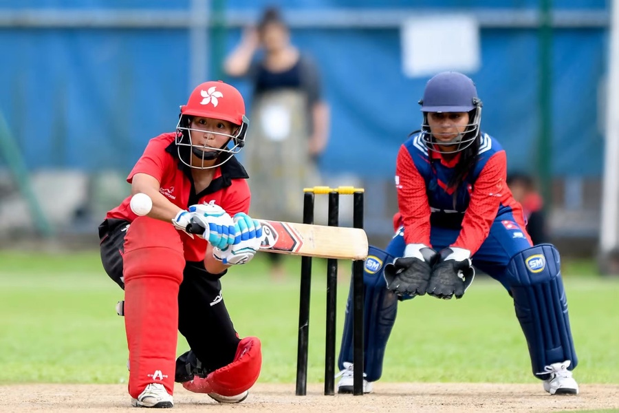 Hong Kong women’s cricket captain Kary Chan prepares to sweep. © HKCC