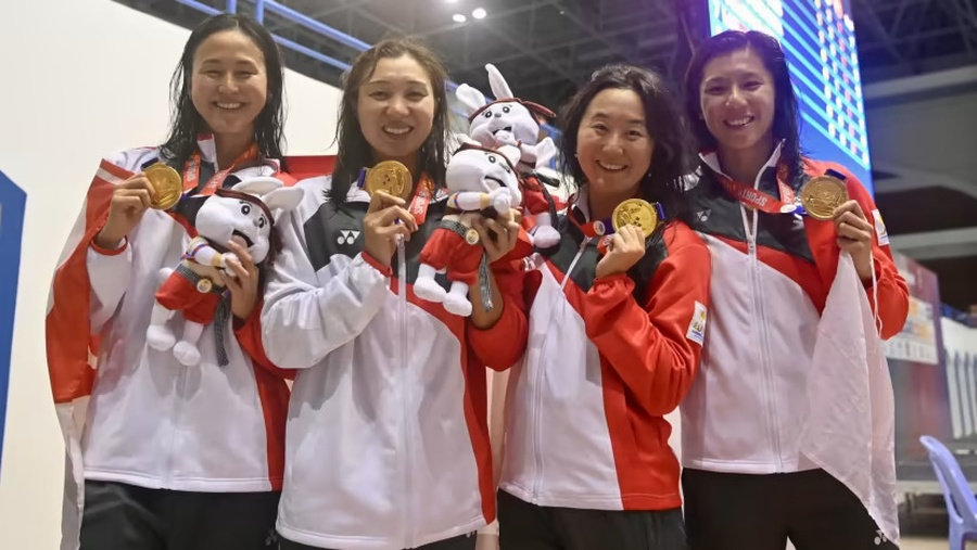 Singapore's women's 4x100m freestyle relay team of (from left) Quah Ting Wen, Nur Marina Chan, Quah Jing Wen and Amanda Lim celebrate their historic gold medal at the Southeast Asian Games on Saturday, May 6, 2023. © CNA/Jeremy Long