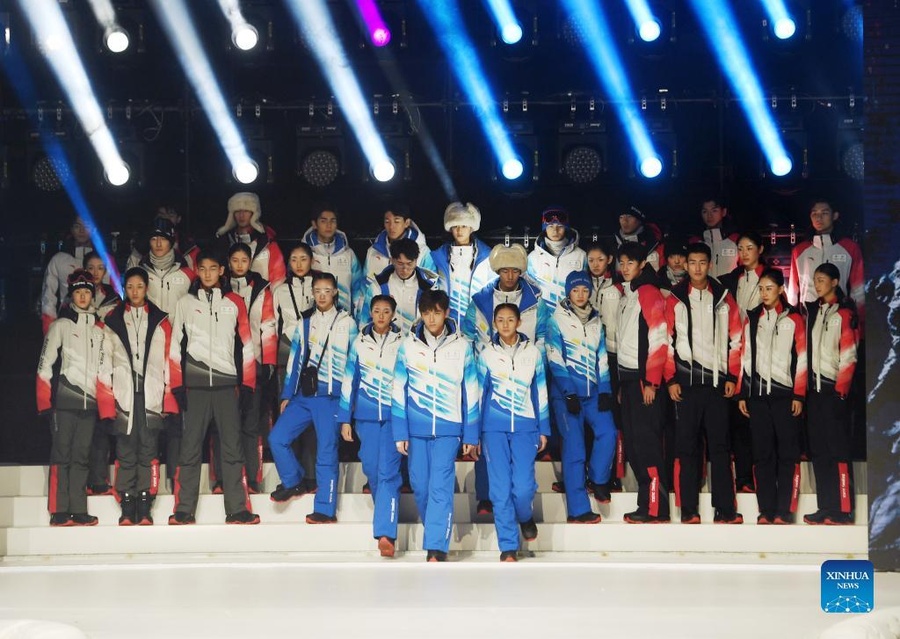 Models display the uniforms for staff (right), technical officials (left) and volunteers at a function to mark 100 days to Beijing 2022 on Wednesday, October 27. © Xinhua/Zhang Chenlin