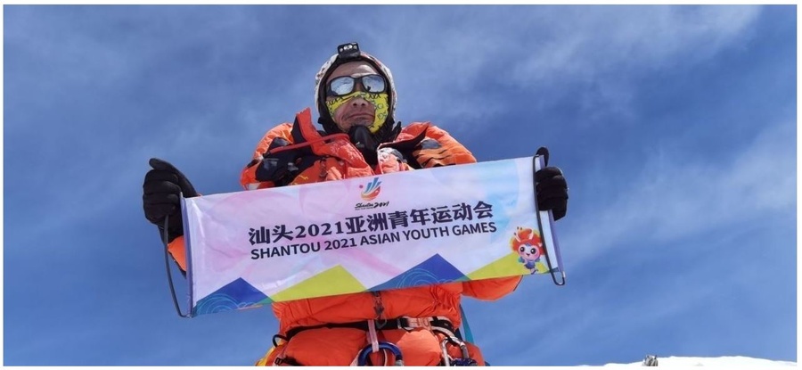 A local citizen reached the summit of Mount Everest and took a photo of himself holding the mascot to promote the sporting event.