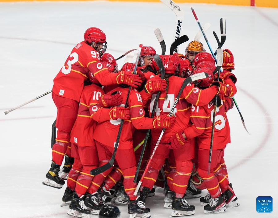 China celebrate their 2-1 victory over Japan at the Wukesong Sports Centre on Sunday (Photo: Xinhua/Meng Yongmin)