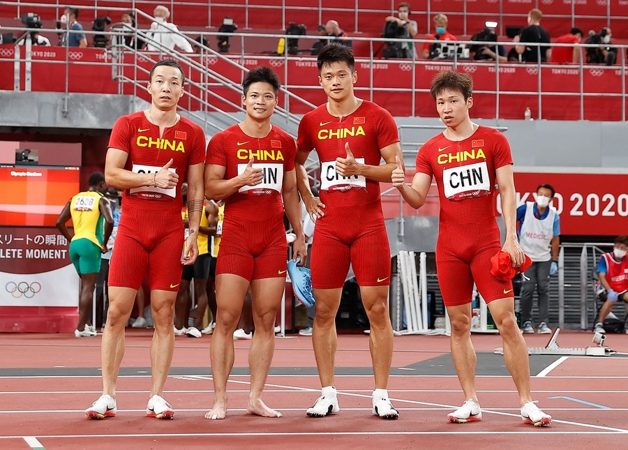 The Chinese team poses for a photo after the men's 4x100m relay final at the Tokyo Olympics on August 6, 2021. From left: Wu Zhiqiang, Su Bingtian, Xie Zhenye, Tang Xingqiang. © Xinhua