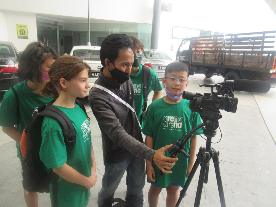 Young athletes take an interest in shooting a video.