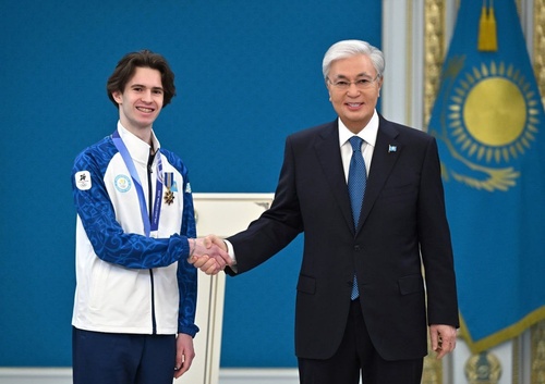 Kazakhstan President Kassym-Jomart Tokayev felicitates Olympic champion Shaidorov