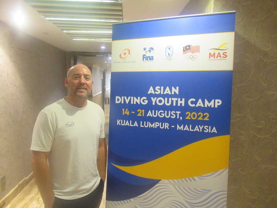 Shannon Roy stands next to the OCA banner at the Pearl Hotel HQ in Kuala Lumpur on Sunday. © OCA