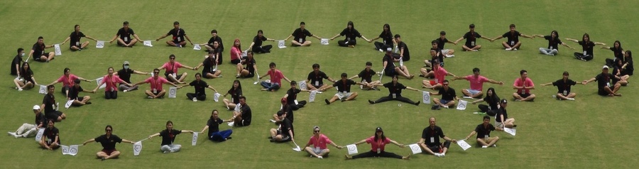 Five rings circled by participants in Kaohsiung National Stadium.