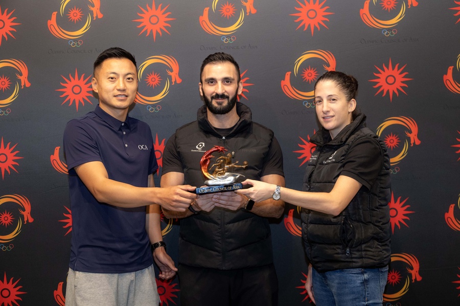 The OCA’s Director of Development Programme and NOC Relations, Wissam Trkmani, is pictured (centre) holding the “Guarding the Asian Games” symbol, flanked by Jamyang Namgyal (left) and Sabine Fakhoury at the Intercontinental Hotel in Bangkok on Tuesday.
