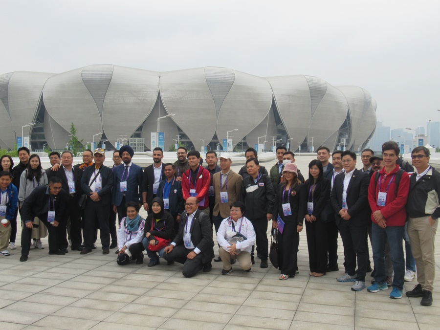 Group photo with the “Big Lotus” main stadium in the background.